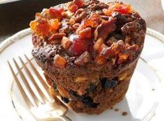 a close up of a muffin on a plate with a fork