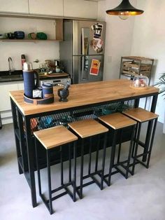 a kitchen island with four stools next to it