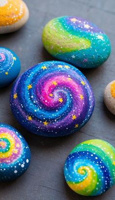 several colorful rocks with stars and swirls painted on them