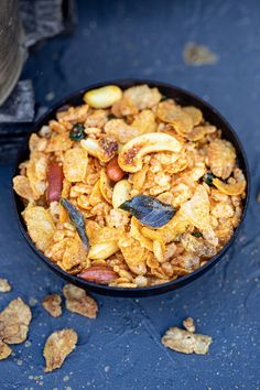 a black bowl filled with cereal and nuts