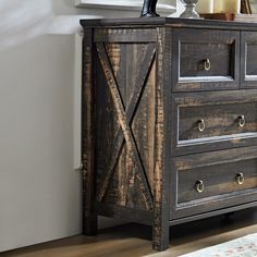 a wooden dresser with three drawers in a room