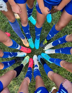 a group of soccer players standing in a circle