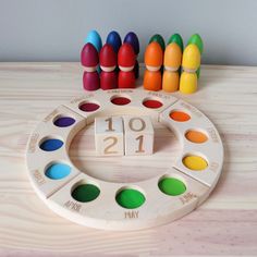 a wooden calendar with colorful crayons sitting next to it