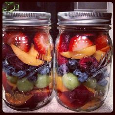 two mason jars filled with different types of fruit