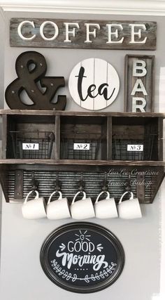 coffee and tea bar sign hanging from the side of a wall with cups on it