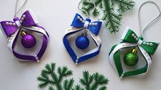 three christmas ornaments with bows and baubles on them