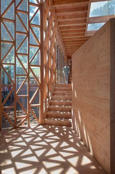 the inside of a building with wooden walls and stairs