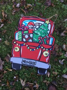 a cardboard cut out of a car with christmas decorations on it sitting in the grass