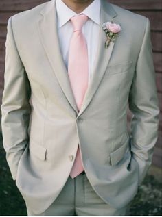 a man in a suit and pink tie