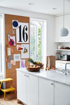 a kitchen with a bowl of fruit on the counter