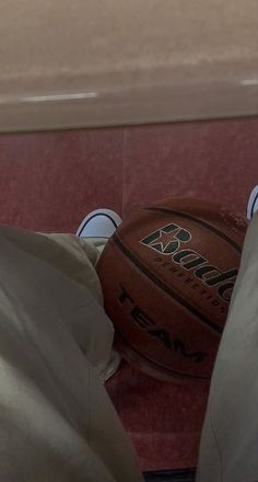 a basketball sitting on top of a white bag