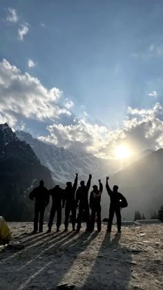 a group of people standing on top of a mountain