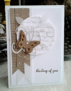 a close up of a greeting card with a butterfly on the front, and an embellishment in the back