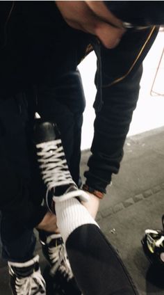 a skateboarder tying his shoes before going down the ramp