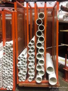 there are many different types of pipes on the rack in this store, all stacked up and ready to be shipped