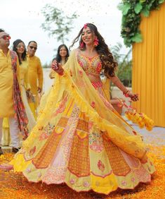 the bride and groom are dressed in bright yellow outfits