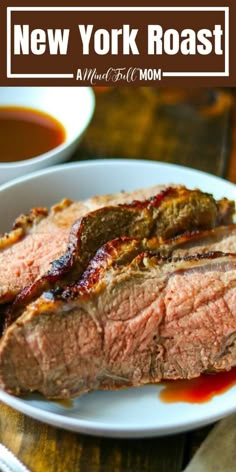 a white plate topped with meat covered in sauce