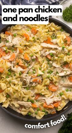 a pan filled with chicken and noodles on top of a table