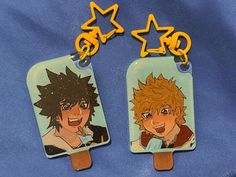 two plastic tags with anime characters on them