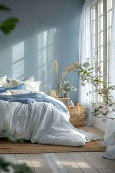 a bedroom with blue walls and white bedding