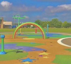 an outdoor play area with lots of colorful paint on the ground