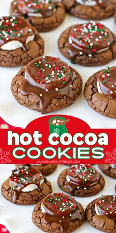 chocolate cookies with sprinkles are on a white plate next to a red sign that says hot cocoa cookies