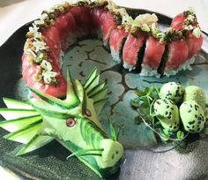 some sushi is on a plate with other food items around it and garnished with sprinkles