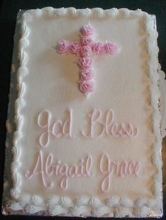 a cake decorated with pink roses and a crucifix on the side that says, god bloss against grace