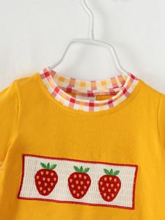 "Cute and comfy, our Yellow Strawberry Baby Boy Romper is perfect for your little one! Made from soft cotton for all-day comfort. Berry-licious style for your little cutie!" 97% Cotton, 3% Spandex Care instructions: Cold wash, gentle cycle, hang dry or tumble dry low inside out, do not bleach, do not iron. Stretch Cotton Tops With Cartoon Print, Stretch Cotton Onesie For Playwear, Cute Cotton Onesie For Spring, Cute Spring Cotton Onesie, Spring Cotton Onesie With Cartoon Print, Sweet Cotton Tops For Playtime, Spring Cotton Onesie For Playtime, Playful Cotton Onesie For Spring, Playful Long Sleeve Onesie For Summer