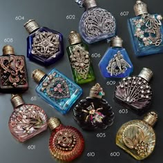 many different colored bottles with designs on them