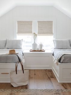 two beds in a room with white walls and wooden floors, one is made up to look like a loft