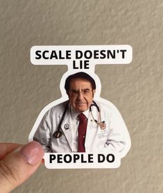 a person holding up a sticker that says scale doesn't lie people do