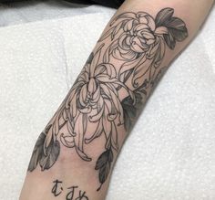 a person with a tattoo on their arm that says it's 75 and has flowers