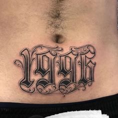 a man's stomach with the word tattoo on it