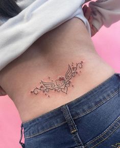 a woman's stomach with a small tattoo design on the side of her belly