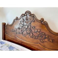 a wooden headboard with an intricate design on the top and bottom part of it