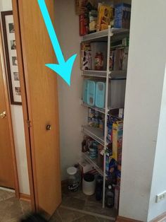 an open pantry door with food and drinks on shelves next to the kitchen counter top