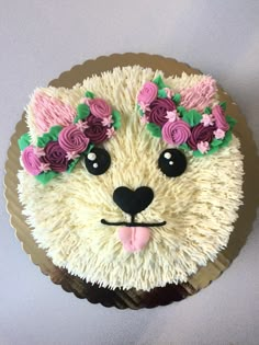 a cake that looks like a cat with flowers on its head