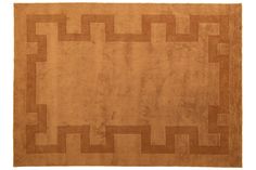 an orange rug with some brown squares on the top and bottom, along with a white background