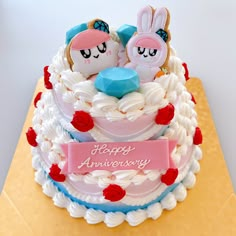 a cake decorated with frosting and decorations on top of a table