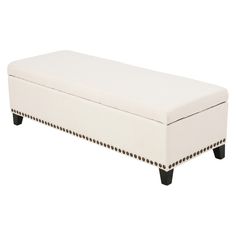 a white bench with black legs and studded trim