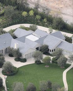 an aerial view of a large house surrounded by trees