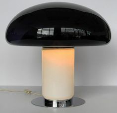 a black table lamp sitting on top of a white counter