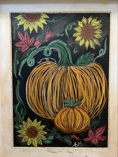 a painting of a pumpkin and sunflowers on a blackboard with white frame