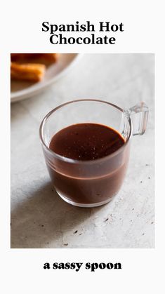 a glass cup filled with chocolate on top of a table