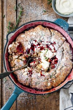 a cake in a pan with powdered sugar on top