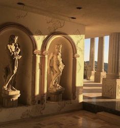 three statues in the middle of a room with columns and arches on either side of them