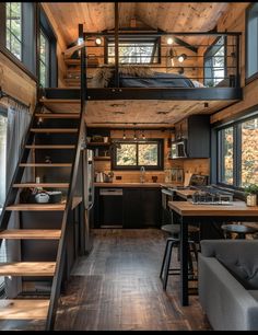 a loft with stairs leading up to the kitchen and living room