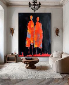 two people standing in front of a large painting on the wall above a coffee table