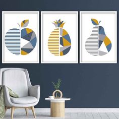 three art prints hanging on the wall next to a white chair and table with a plant in it